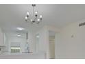 Modern kitchen with white cabinets, quartz countertops and a chandelier at 4210 Caddie E Dr # 102, Bradenton, FL 34203