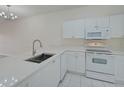 White kitchen with stainless steel appliances and ample counter space at 4210 Caddie E Dr # 102, Bradenton, FL 34203