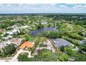 Aerial view of a lakefront community with luxury homes at 4431 Camino Real, Sarasota, FL 34231