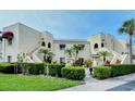 Two-story building with stucco exterior, featuring manicured landscaping and a welcoming entrance at 6101 34Th W St # 15B, Bradenton, FL 34210