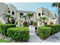 Two-story building with stucco exterior, featuring manicured landscaping and a welcoming entrance at 6101 34Th W St # 15B, Bradenton, FL 34210