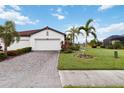 Two-car garage home with tile driveway and landscaping at 11722 Bluebird Pl, Bradenton, FL 34211