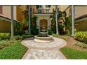 Elegant courtyard entry with fountain and landscaping at 393 N Point Rd # 801, Osprey, FL 34229