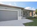 Single story home with gray exterior and screened porch at 11213 Gulfstream Blvd, Port Charlotte, FL 33981