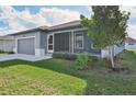 Single story home with gray exterior and screened porch at 11213 Gulfstream Blvd, Port Charlotte, FL 33981