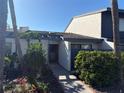 Condo exterior features lush landscaping and a walkway to the front door at 7234 Cloister Dr # 7234, Sarasota, FL 34231