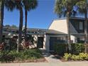 Condo featuring mature landscaping and a shady walkway to the front door at 7234 Cloister Dr # 7234, Sarasota, FL 34231