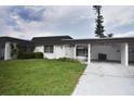 Exterior of a villa featuring a carport and neatly landscaped yard at 3961 Ashwood Ln # 44, Sarasota, FL 34232