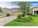 Two-car garage villa exterior with lush landscaping at 2934 Trustee Ave, Sarasota, FL 34243