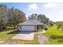 One-story house on a large lot with a spacious yard and driveway at 424 Logue Rd, Myakka City, FL 34251