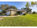 One-story home with attached garage and solar panels at 424 Logue Rd, Myakka City, FL 34251