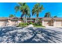 Front view of condo building, featuring attached garages and lush landscaping at 5271 Mahogany Run Ave # 713, Sarasota, FL 34241