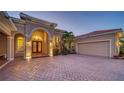 Elegant home entrance with double doors and paver driveway at 6918 73Rd E Ct, Bradenton, FL 34203