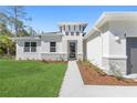Front entrance with walkway, stone accents, and landscaping at 2938 Woodward Ave, North Port, FL 34286