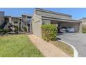 Covered parking for two cars with lush green landscaping at 232 Woodland Dr, Osprey, FL 34229