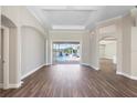 Spacious living room with hardwood floors and sliding glass doors leading to the pool at 11332 Rivers Bluff Cir, Lakewood Ranch, FL 34202