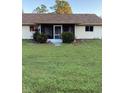 Rear view of house with screened porch and neat lawn at 4601 Ulster Ave, North Port, FL 34287