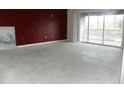 Spacious living room with dark red accent wall and sliding glass doors at 2086 Kings Palace Dr # 2086, Riverview, FL 33578