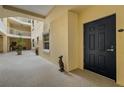 Building hallway with a black door to a condo unit at 14041 Bellagio Way # 214, Osprey, FL 34229
