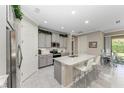 Modern kitchen with gray cabinets and granite island at 123 Pescador Pl, Nokomis, FL 34275