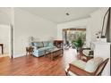 Bright living room with hardwood floors, comfy seating, and access to a screened porch at 7341 Featherstone Blvd, Sarasota, FL 34238