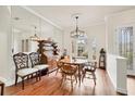 Formal dining room with hardwood floors and large window at 7341 Featherstone Blvd, Sarasota, FL 34238