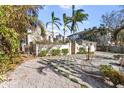 Home's exterior showcasing landscaping and driveway at 8213 Midnight Pass Rd, Sarasota, FL 34242