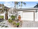 Elegant home exterior with gated entry and a large garage at 8213 Midnight Pass Rd, Sarasota, FL 34242
