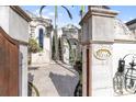 Grand entrance with ornate gate and stonework at 8213 Midnight Pass Rd, Sarasota, FL 34242