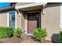 Front door entry with landscaping and a brick walkway at 5016 Savona Run, Bradenton, FL 34211