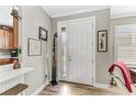 Bright and airy entryway with hardwood floors and access to the kitchen at 5016 Savona Run, Bradenton, FL 34211