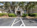 Community building entrance with landscaping and parking at 5122 Northridge Rd # 207, Sarasota, FL 34238