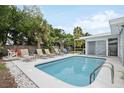Inviting backyard oasis featuring a refreshing pool, lounge chairs, and lush landscaping at 2425 Clematis St, Sarasota, FL 34239