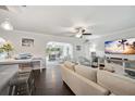 Open-concept living room with a large TV and comfortable seating at 2425 Clematis St, Sarasota, FL 34239