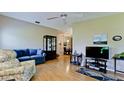 Living room with hardwood floors, seating area, and view to dining area at 2911 74Th W St # 2276, Bradenton, FL 34209