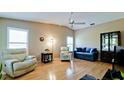 Living room with hardwood floors, seating area, and built-in cabinet at 2911 74Th W St # 2276, Bradenton, FL 34209