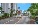 Condo community entrance with gated access and lush landscaping at 9397 Midnight Pass Rd # 505, Sarasota, FL 34242