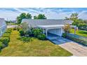 Single-story home with carport and lush landscaping at 9414 Andover Cir, Bradenton, FL 34210