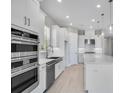 Modern kitchen with stainless steel appliances, double ovens and white cabinetry at 10442 Morning Mist, Sarasota, FL 34241