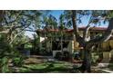 Exterior view of condo building with Spanish tile and lush landscaping at 6466 Seagull Dr # 323, Bradenton, FL 34210