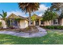 One-story house with stone accents and a manicured lawn at 22575 Morning Glory Cir, Bradenton, FL 34202