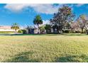 One-story house with palm trees and a large yard at 22575 Morning Glory Cir, Bradenton, FL 34202