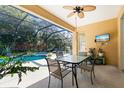 Enclosed patio with pool, spa, table, and chairs at 11734 Hidden Forest Loop, Parrish, FL 34219