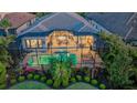 Aerial view of a screened in pool, covered patio, and meticulous landscaping in the backyard at 7928 Matera Ct, Lakewood Ranch, FL 34202