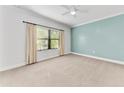 Bright bedroom with neutral carpeting and an accent wall at 1269 Backspin Dr, Englewood, FL 34223