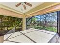 Bright screened porch with view of tropical landscape at 1269 Backspin Dr, Englewood, FL 34223