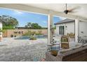 View of the pool area and patio furniture with a ceiling fan at 1109 The Rialto, Venice, FL 34285