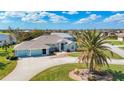 Single-Gathering home with circular driveway and palm tree at 54 Medalist Pl, Rotonda West, FL 33947