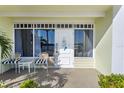 Inviting condo exterior featuring a private patio with seating for two at 611 Destiny Dr # 107, Ruskin, FL 33570