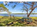 Relaxing waterfront view with picnic tables and grills at 611 Destiny Dr # 107, Ruskin, FL 33570